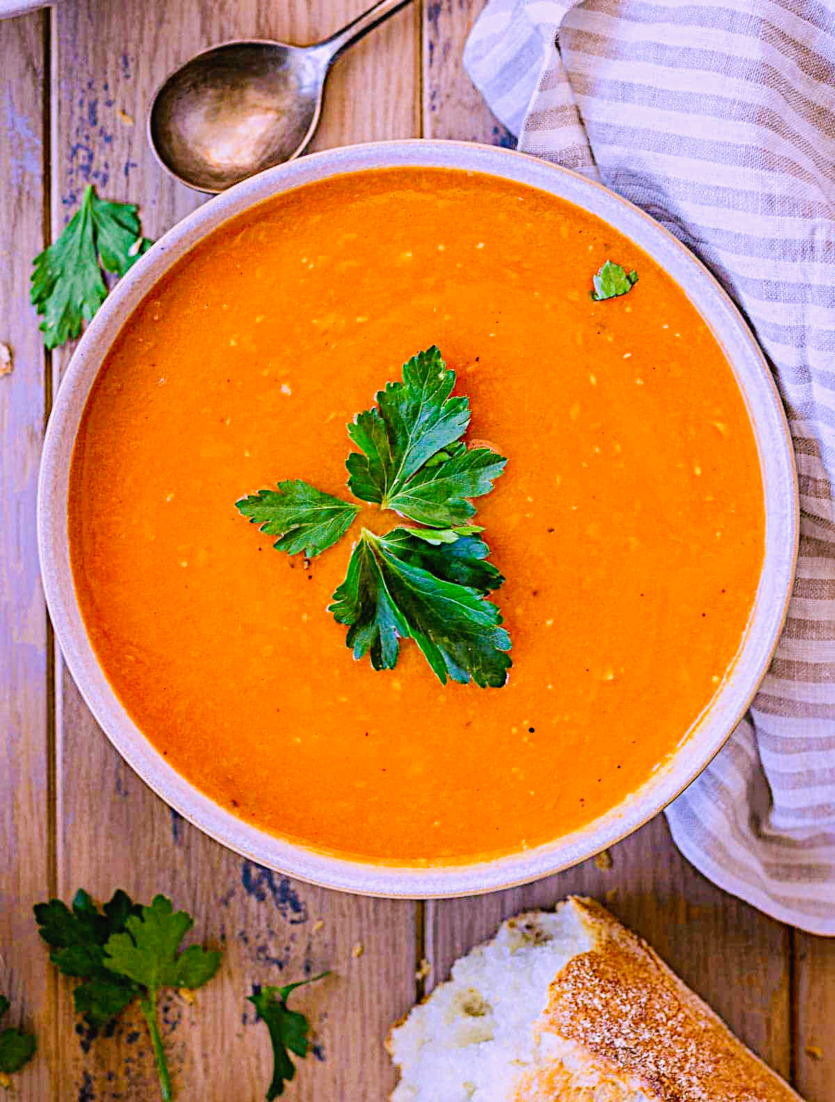Creamy tomato soup with parsley garnish